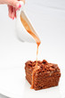 Sweet honey-cake with caramel sauce on a white plate