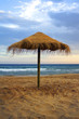 Sun umbrella near the sea at sunset Sun umbrella near the sea at sunset