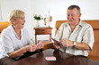 Seniorin und Senior spielen Karten 01