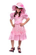 Serious girl wearing pink dress, hat and high-heel shoes