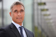 Business executive stood outdoors