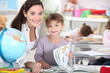a female teacher and a little girl in a classroom