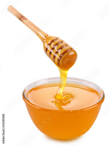 Photo: Bowl of honey and wooden stick. Bowl of honey and wooden stick.