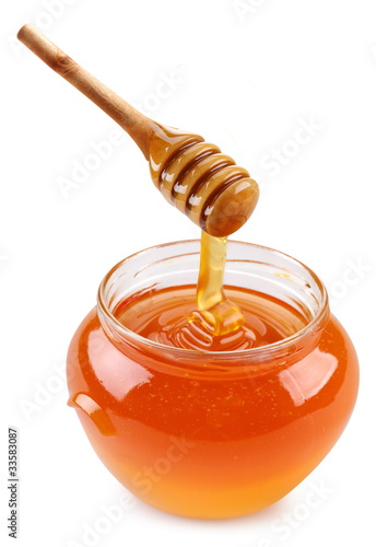 Photo: Pot of honey and wooden stick. Pot of honey and wooden stick.