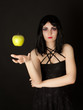 Woman with halloween make up sthrowing green apple Woman with halloween make up sthrowing green apple