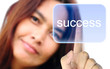 women hand pushing success button on a touch screen interface