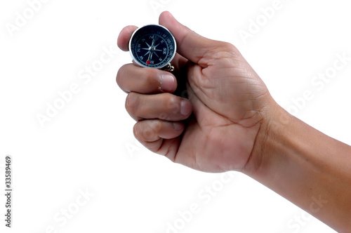 Photo: man's hand holding a compass man's hand holding a compass