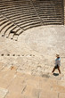 Tourist woman walking around ancient amphitheatre Tourist woman walking around ancient amphitheatre