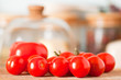 Ripe tomatoes with cheese under glass in background