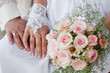 Hands and rings with wedding bouquet Hands and rings with wedding bouquet