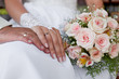 Hands and rings with wedding bouquet Hands and rings with wedding bouquet