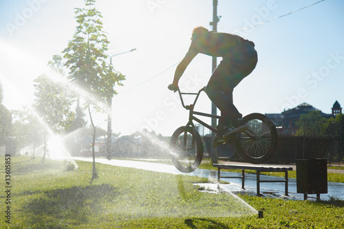 Photo: boy jumping over fountain on bmx boy jumping over fountain on bmx