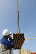 building worker directing crane load