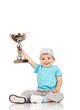 small boy holding a winners cup