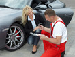 Mechanic giving car key to a business woman customer outdoors