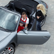 Master mechanic explaining repair costs to a customer outdoors