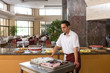 Waiter serving dessert for buffet