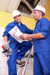 Workers discussing a drawing