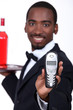 Male server holding mobile telephone