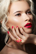 Blond model with fashion make-up, bright manicure & accessory
