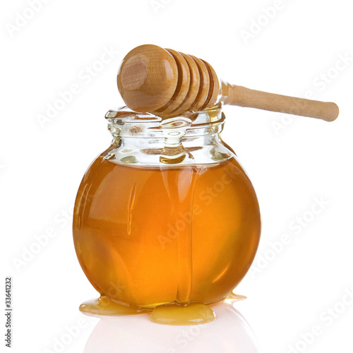 Photo: glass jar of honey and stick isolated on white glass jar of honey and stick isolated on white