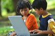 Boy and girl using Computer and gadget