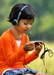 Photo: Young girl listening to music with a headset Young girl listening to music with a headset
