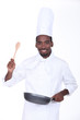 Chef with a pan and wooden spoon