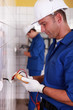 Electricians installing switches