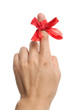 Red bow on finger