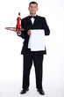 Waiter holding tray with wine bottle