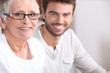 Senior woman sitting with a young man