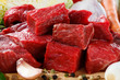 Raw beef on cutting board and vegetables