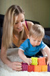 Photo: Young mother playing with baby boy Young mother playing with baby boy