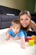 Photo: Young mother playing with baby boy Young mother playing with baby boy