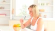 Blond-haired woman taking an apple