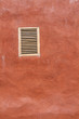 Vintage window on red cement wall