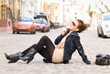 Photo: fashionable girl sitting on the street fashionable girl sitting on the street