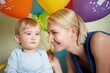 Happy mother with her baby celebrating birthday