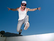 Photo: tattoed male parkour free runner jumping forward tattoed male parkour free runner jumping forward