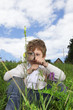 boy with magnifying glass outdoors