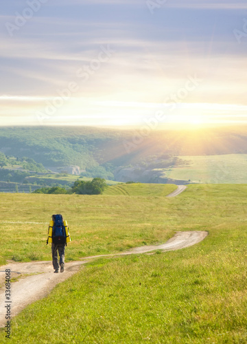 Photo: Man tourist in mountains. Leisure activity. Man tourist in mountains. Leisure activity.