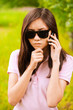 portrait of woman in sunglasses with phone