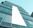 blue glass wall with blank placard of skyscraper