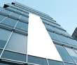 blue glass wall with blank placard of skyscraper