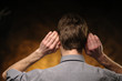 Man with hands on ears