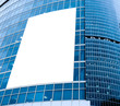 blue glass wall with blank placard of skyscraper