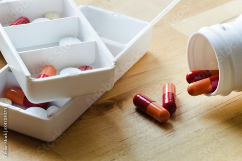 Photo: Pills, capsules and tablets sorted in pillbox Pills, capsules and tablets sorted in pillbox