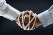 Binding business handshake with rope Binding business handshake with rope