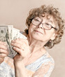 senior happy woman with money